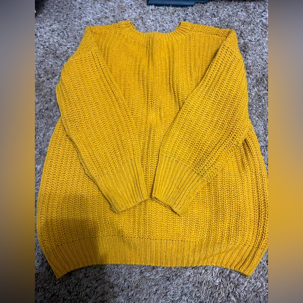 Mustard color sweater.
